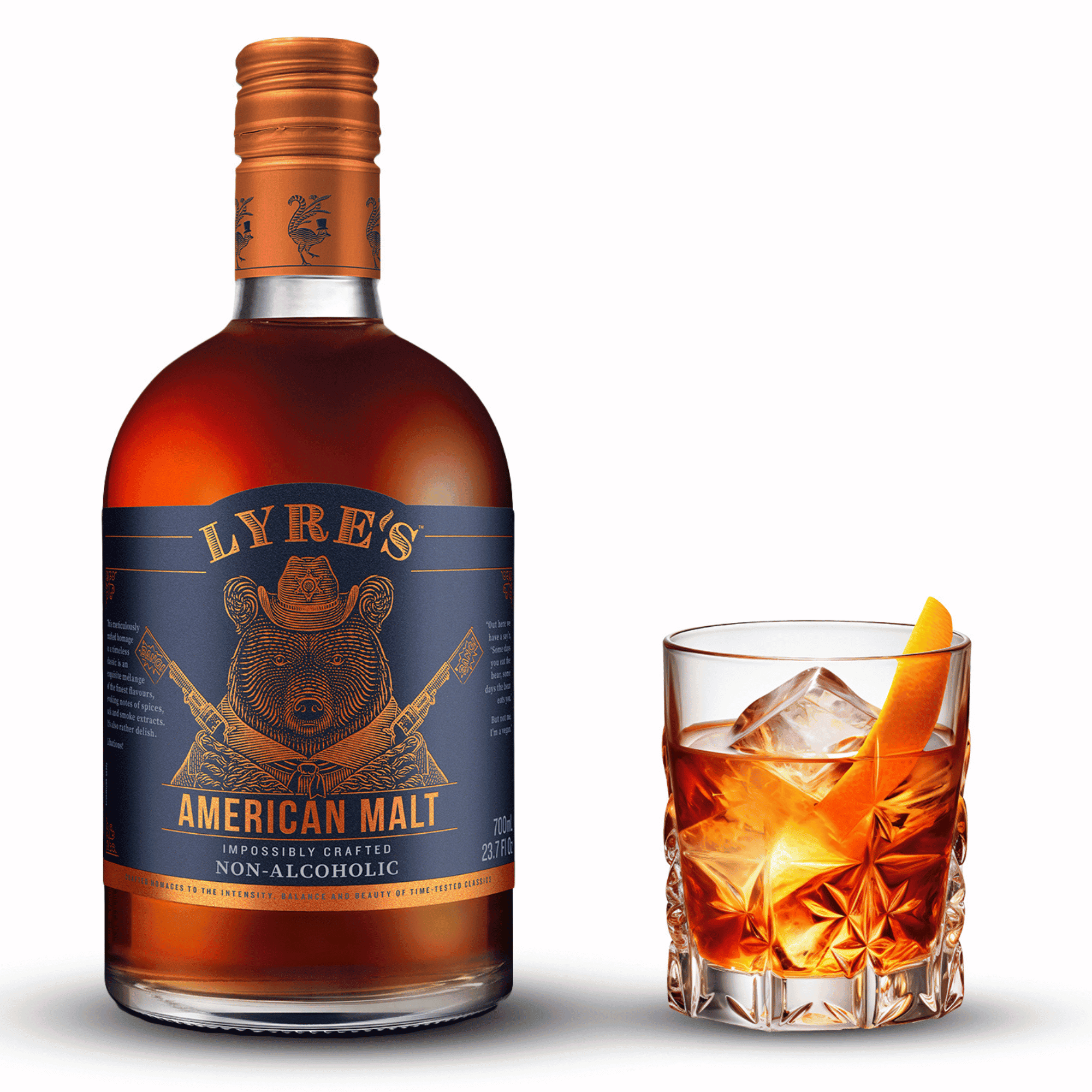 Bottle of Lyre's American Malt non-alcoholic with a glass of Old Fashioned mocktail on a white background