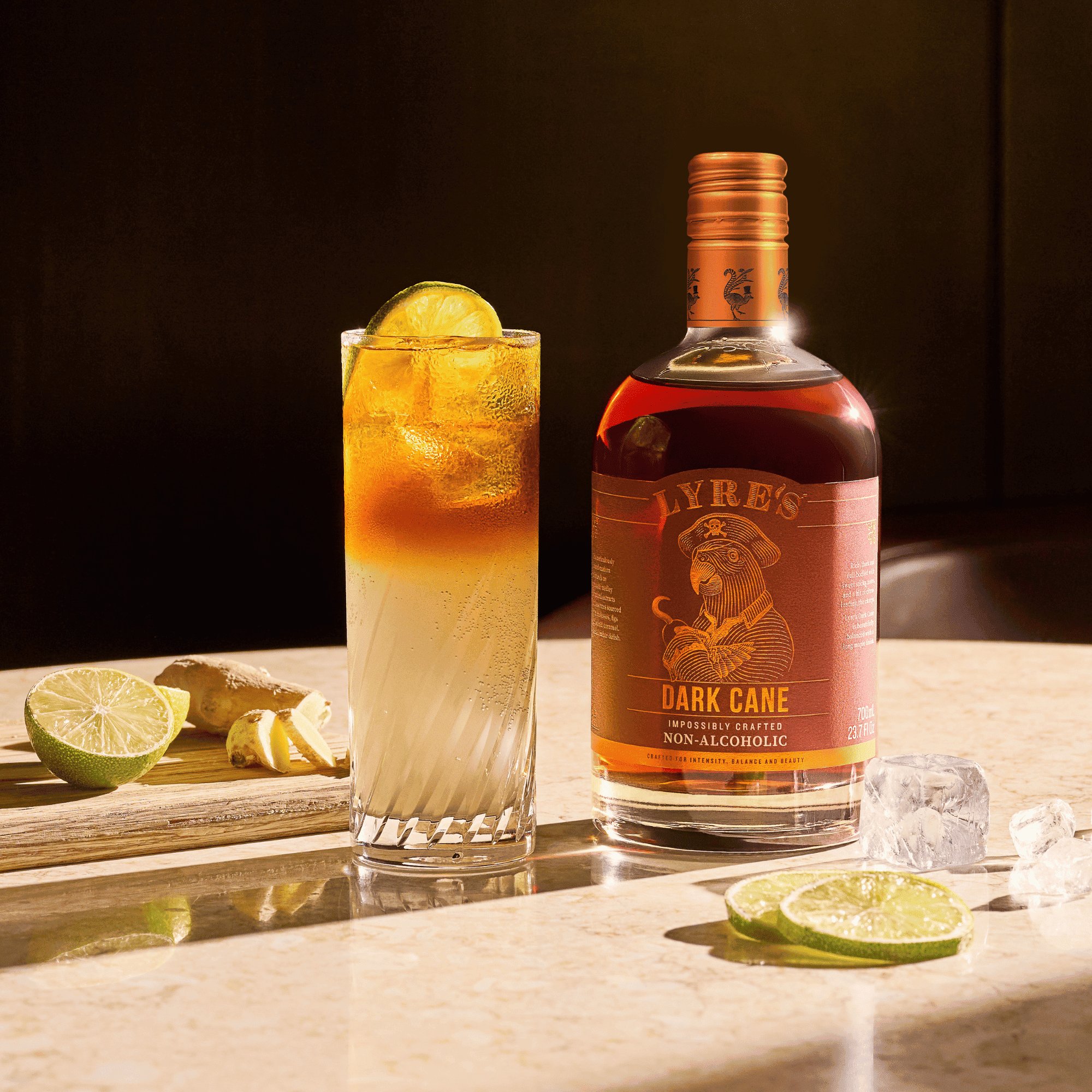 Bottle of Lyre's Dark Cane non-alcoholic rum alternative with a cocktail and lime slices.
